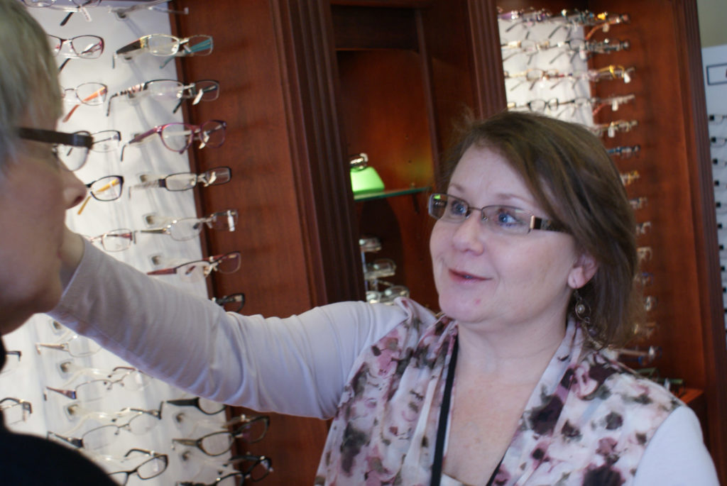 SONY DSC Adjusting eye glasses on woman's face