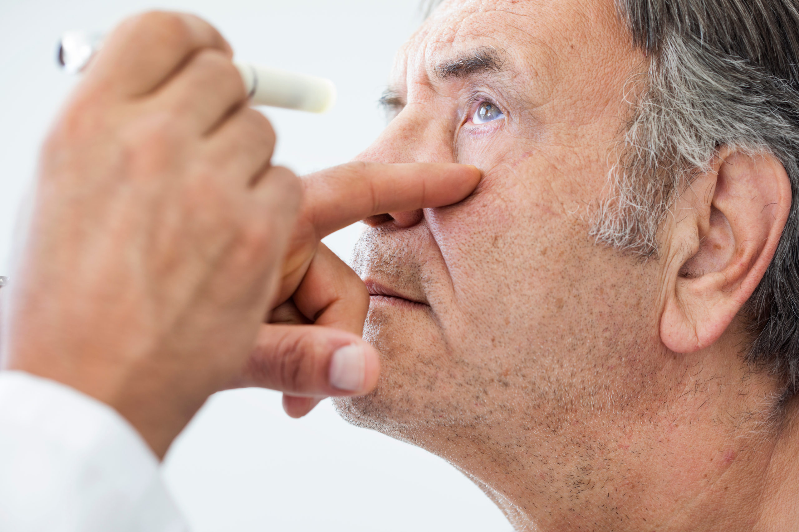 Elderly man examined by an ophthalmologist Elderly man examined by an ophthalmologist
